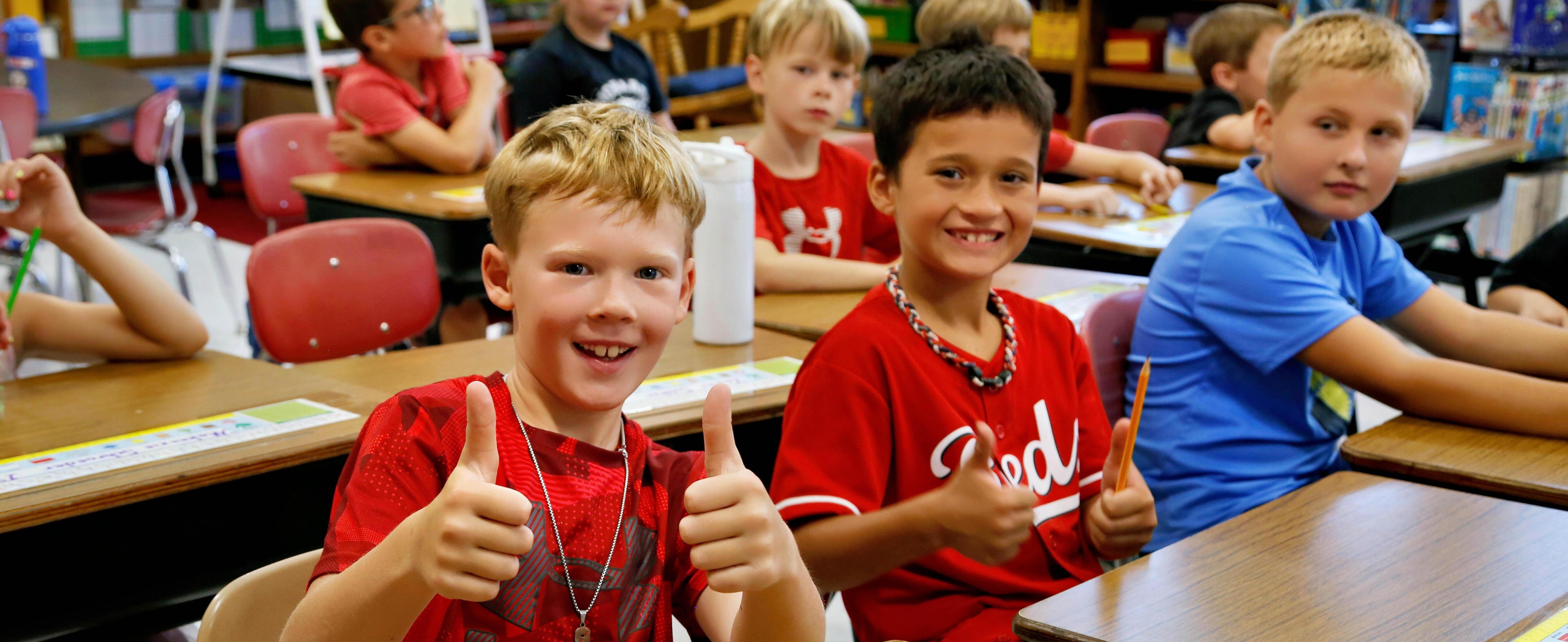 Students giving thumbs up