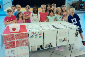 students selling at the grade 1 marketplace